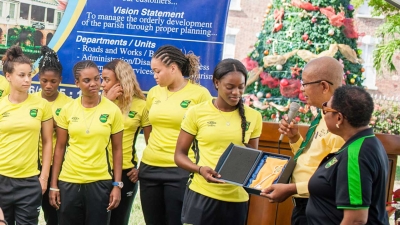 The Mayor of Spanish Town, His Worship Councillor Norman Scott, presents the Key to Spanish Town to the Captain of the Reggae Girlz, Konya Plummer. Looking on is the Minister of Culture, Gender, Entertainment and Sport, the Honourable Olivia Grange. The presentation was part of the celebrations honouring the qualification of the national team to the FIFA Women&#039;s World Cup.
