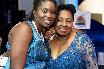 Minister of Culture, Gender, Entertainment and Sport, the Honourable Olivia Grange, shares a moment with adolescent mother Yasheka Brooks. The Minister has offered to clear the balance on Miss Brooks&#039; tuition fees.