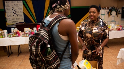 The Minister of Culture, Gender, Entertainment and Sport, the Honourable Olivia Grange presents a &#039;dignity package&#039; to an adolescent mother registered with the Women&#039;s Centre of Jamaica Foundation.