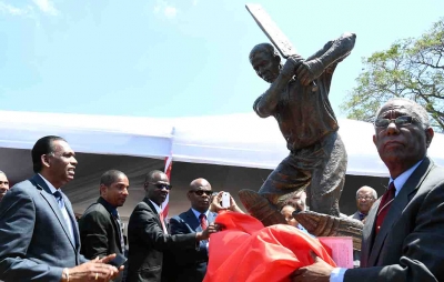 Completing the unveiling of the Collie Smith stature are: Denzil Thorpe, Permanent Secretary, Ministry of Culture, Gender, Entertainment and Sport; (3rd left); Billy Heaven, CEO, Chase Fund and President, Jamaica Cricket Association (JCA); Senator Councillor Delroy Williams, Mayor of Kingston; Honourable Steadman Fuller, Custos Rotulorum of Kingston (left to right) and Lyndel Wright, brother, Collie Smith and Former President of the JCA (right).
