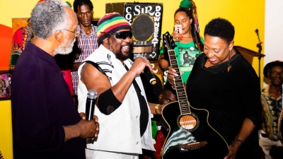 The Minister of Culture, Gender, Entertainment and Sport, the Honourable Olivia Grange (right) accepts a donation from Reggae legend, Toots Hibbert, to the Jamaica Music Museum.  The Director of the Museum, Herbie Miller (left) looks on.