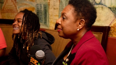 The Minister of Culture, Gender, Entertainment and Sport, the Honourable Olivia Grange, makes a point at news conference in Kingston. Looking on is Grammy Award-winning artiste, Koffee